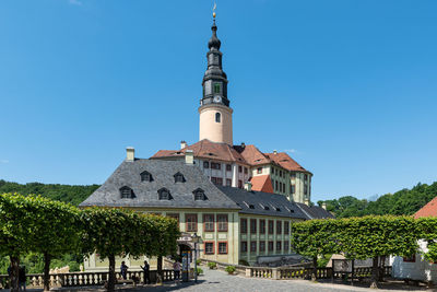 Low angle view of building against clear blue sky