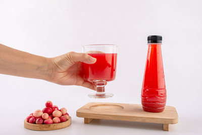 Cropped hand of woman holding drink