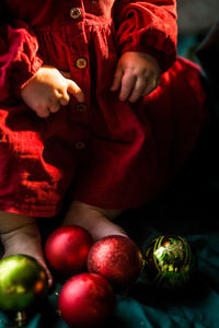 Close-up of baby  holding christmas decoration 