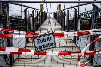 Information sign on railing of bridge