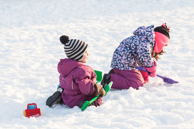 Rear view of women in snow