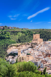 View of spanish white town with castle and bell tower, alcalá del júcar, castilla la mancha, spain