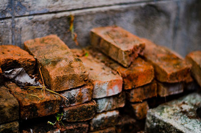 Close-up stack of bricks against wall