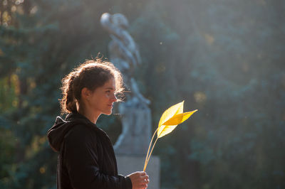 Portrait of woman holding outdoors