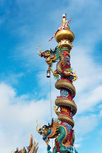 Low angle view of statue against sky