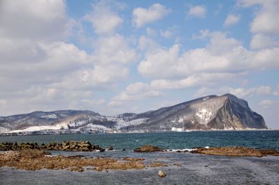 Scenic view of mountains against cloudy sky