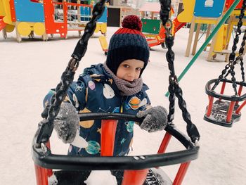 High angle view of boy sitting on slide