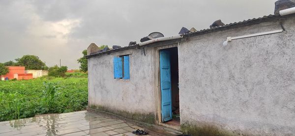 Houses by street against sky