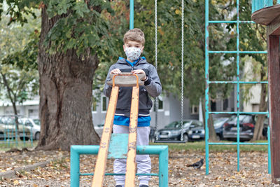 Portrait of boy sitting on playground