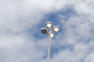 Low angle view of street lights against sky