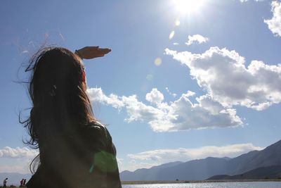 Woman standing against sky