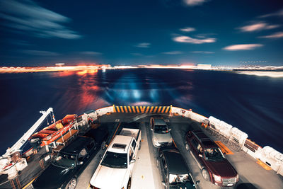 High angle view of illuminated ship in sea against sky