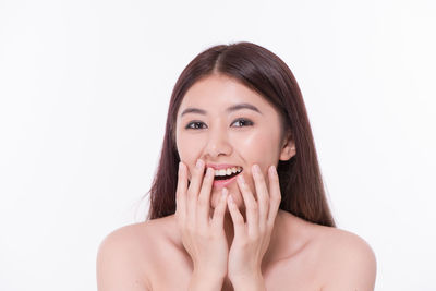 Portrait of a smiling young woman over white background