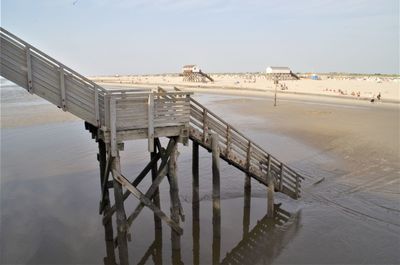 High angle view of pier on beach against sky