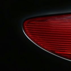 Close-up of illuminated red light against black background