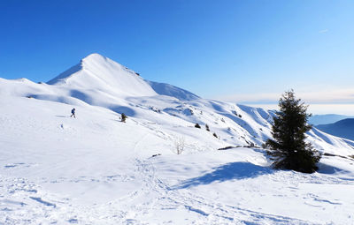 Snowcapped mountain against blue sky