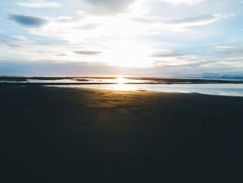 View of beach against cloudy sky