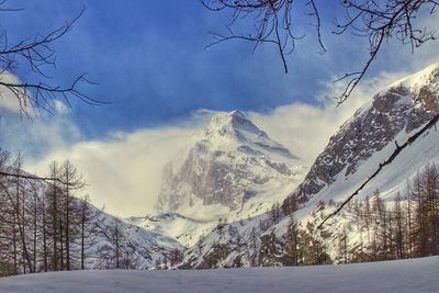 Scenic view of snow covered mountains against sky