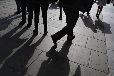 Low section of people walking on footpath