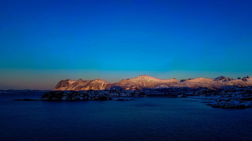 Scenic view of sea against clear blue sky