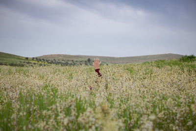 Man standing on field against sky