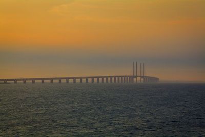 Scenic view of sea against orange sky