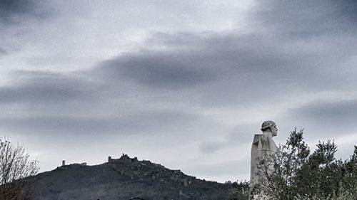 Low angle view of statue against sky