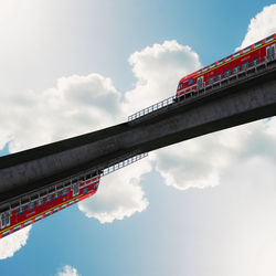 Low angle view of bridge against cloudy sky