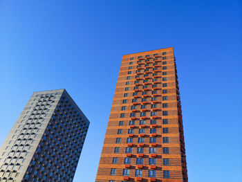 Low angle view of modern building against clear blue sky