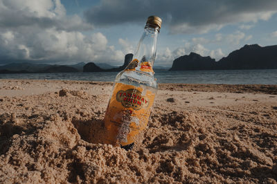 Panoramic shot of water bottle on beach against sky