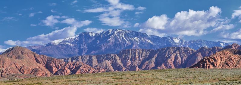 Panoramic view of mountain range against cloudy sky