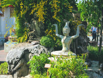 Statue amidst trees in park