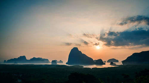 Scenic view of silhouette mountains against sky during sunset