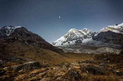 Scenic view of snowcapped mountains against clear sky