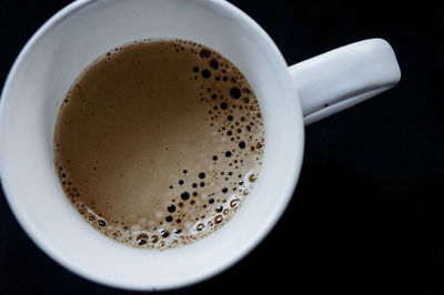 Close-up of coffee cup against black background