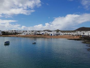 View of town against cloudy sky