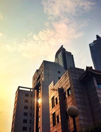 Low angle view of building against cloudy sky