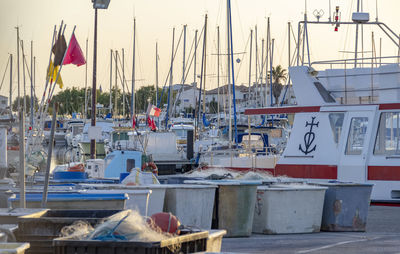 Sailboats moored at harbor