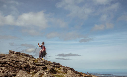 Woman hiking on rocky mountain