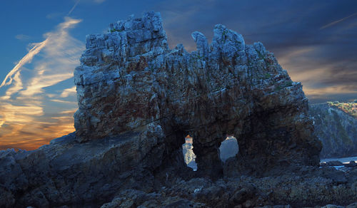 Rock formation on mountain against sky