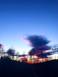 Low angle view of silhouette trees against clear sky