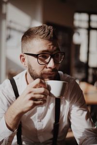 Midsection of man drinking coffee