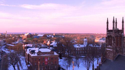 Buildings in city at sunset