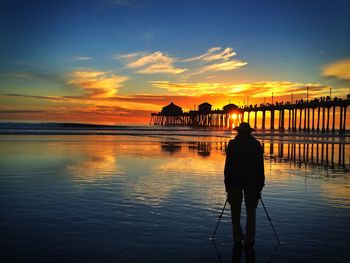 Silhouette of pier at sunset