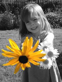 Portrait of young woman holding flower