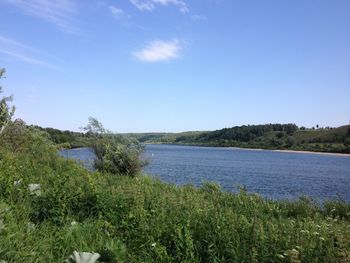 Scenic view of lake against clear blue sky
