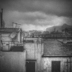 Buildings against cloudy sky