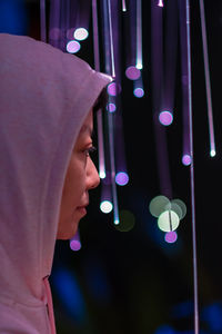 Close-up portrait of woman with illuminated lights
