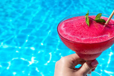 Cropped hand holding drink