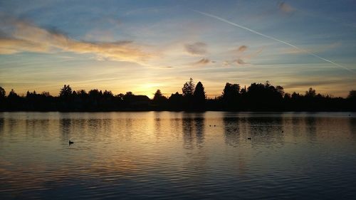 Scenic view of lake against sky during sunset